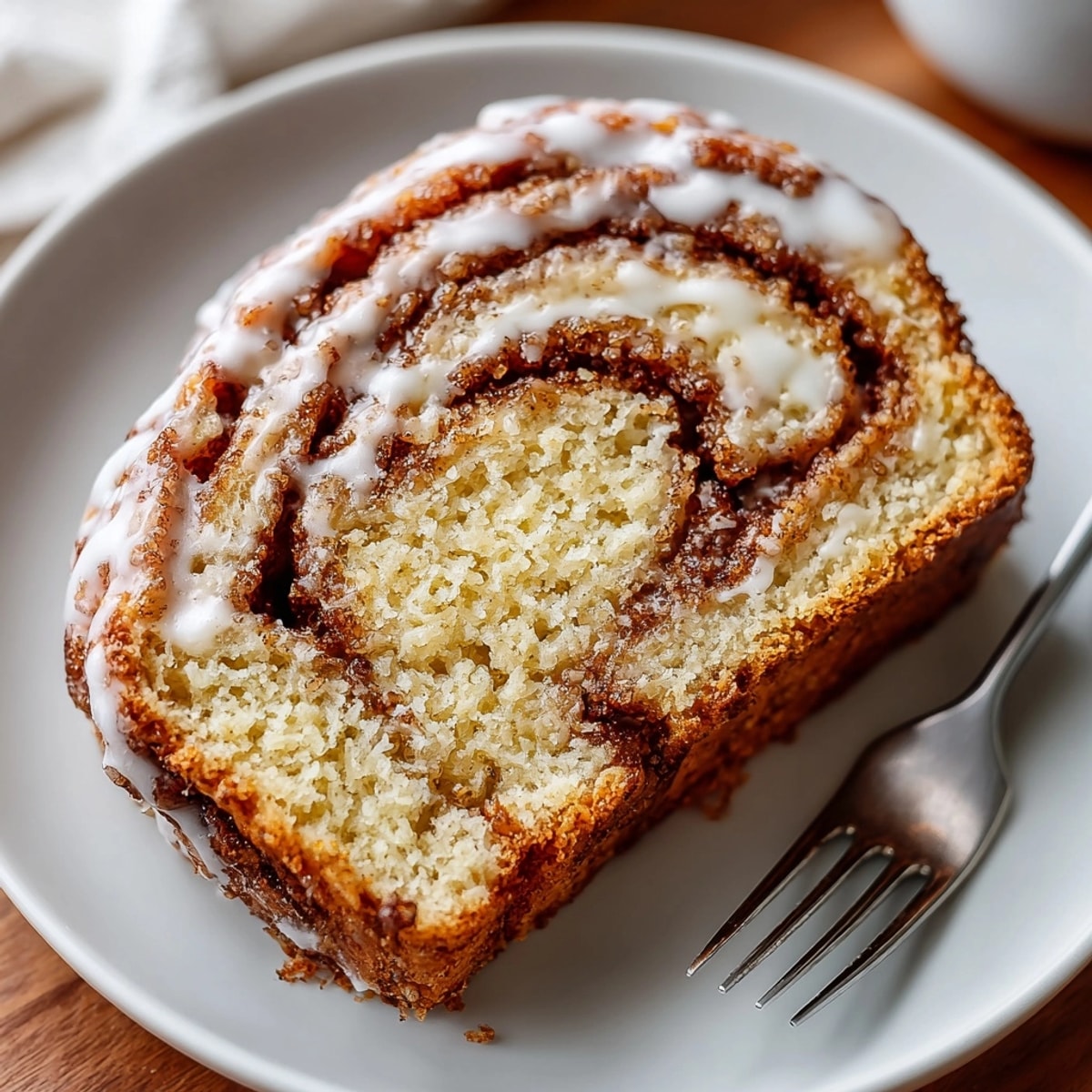 Warm, inviting photo of freshly baked Brown Butter Cinnamon Roll Bread, with swirls of cinnamon sugar inside.