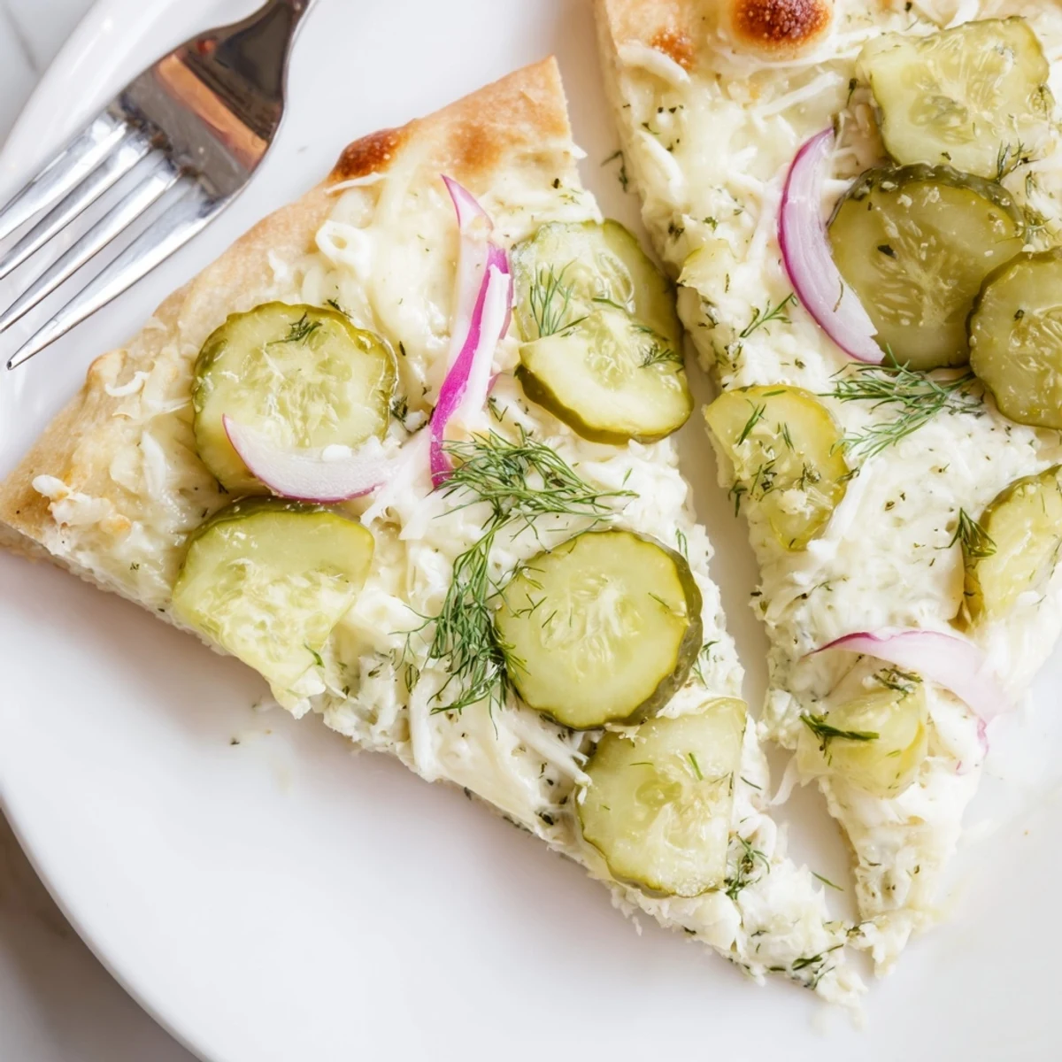 Creamy pickle pizza topped with mozzarella and crunchy dill for unique flavor.  