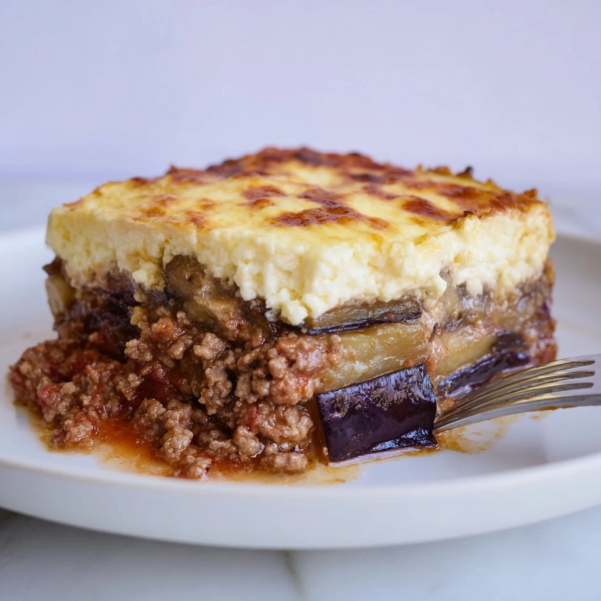 Delicious Moussaka featuring rich ground beef and roasted eggplant, perfect for family dinners.