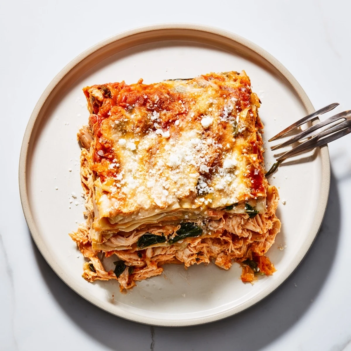 Savory rosemary chicken lasagna layered with creamy béchamel and bubbly mozzarella.  