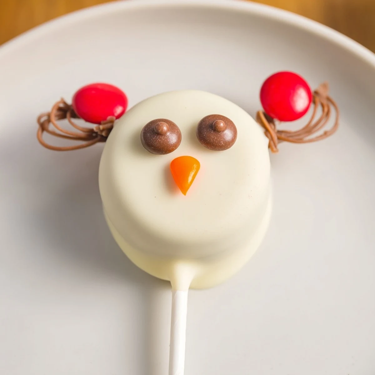 White chocolate-covered Budget-Friendly Oreo Snowman Pops, cheerful and festive, perfect treats for winter.