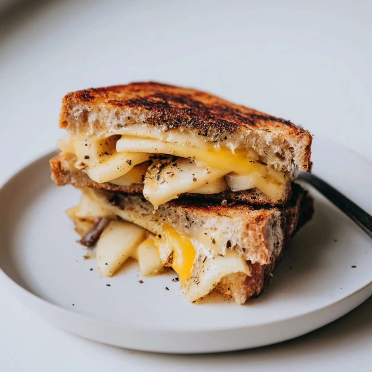 Golden, bubbly Caramelized Onion, Apple & Cheddar Grilled Cheese, ready to delight your taste buds.