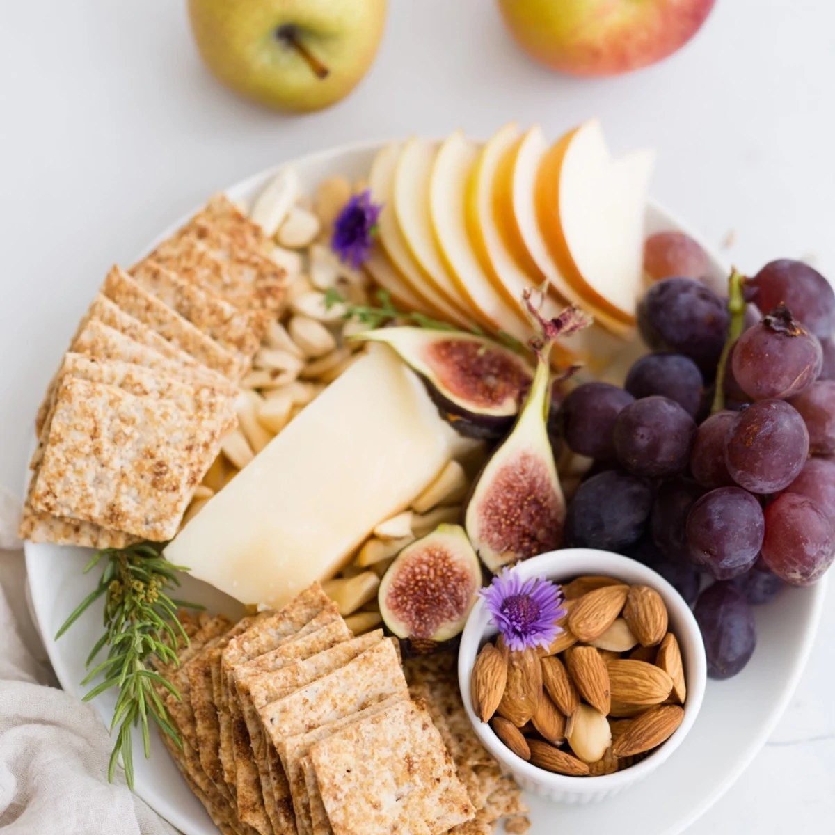 Beautiful Golden Wheat Bundle Board appetizer showcasing cheese, apple slices, grapes, and almonds for a party.