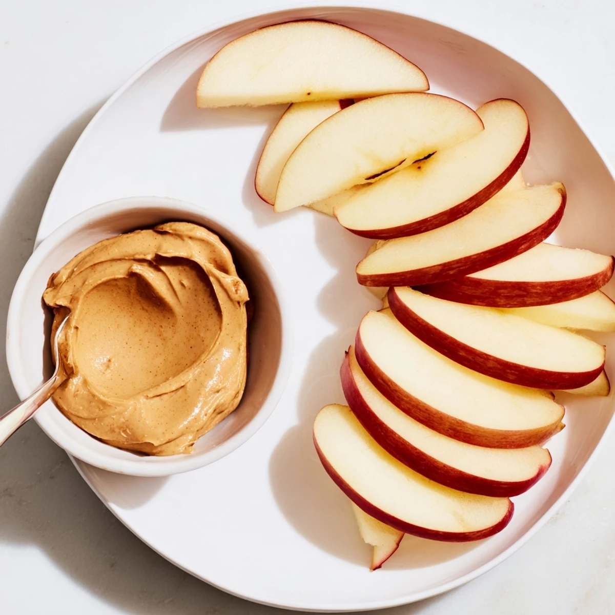 Crisp apple slices await, ready to be dipped into a creamy peanut butter dip.