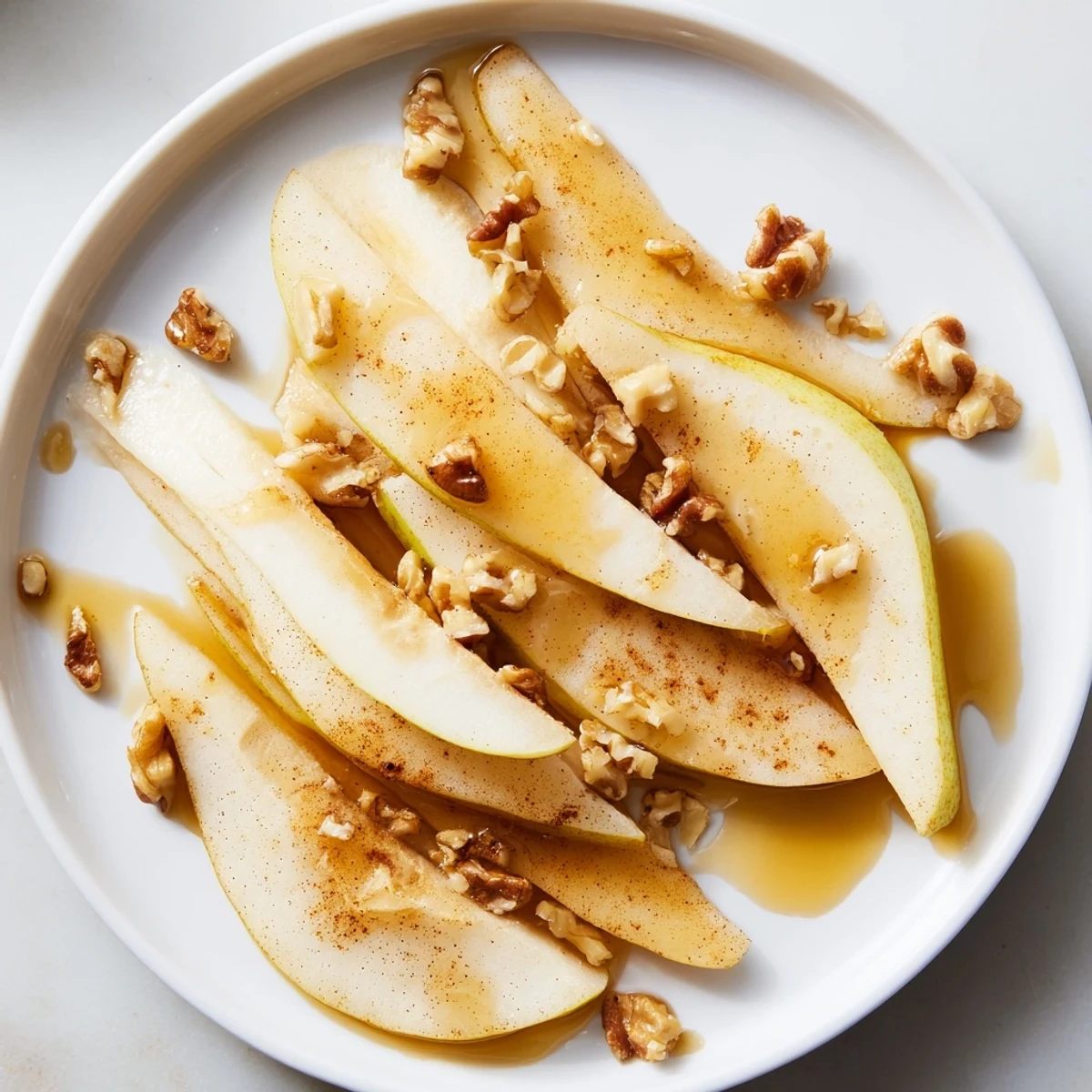 Fresh pear slices with golden honey drizzle, a simple way to enjoy this delicious snack.
