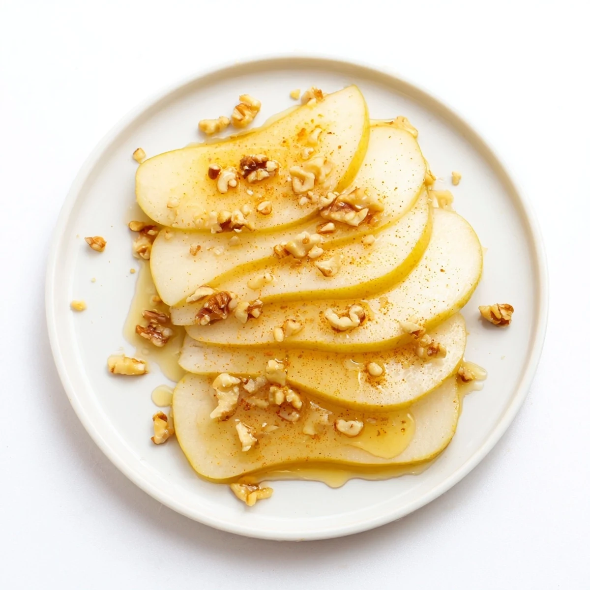 Close-up of juicy pear slices and honey drizzle, perfect for a light, easy treat.
