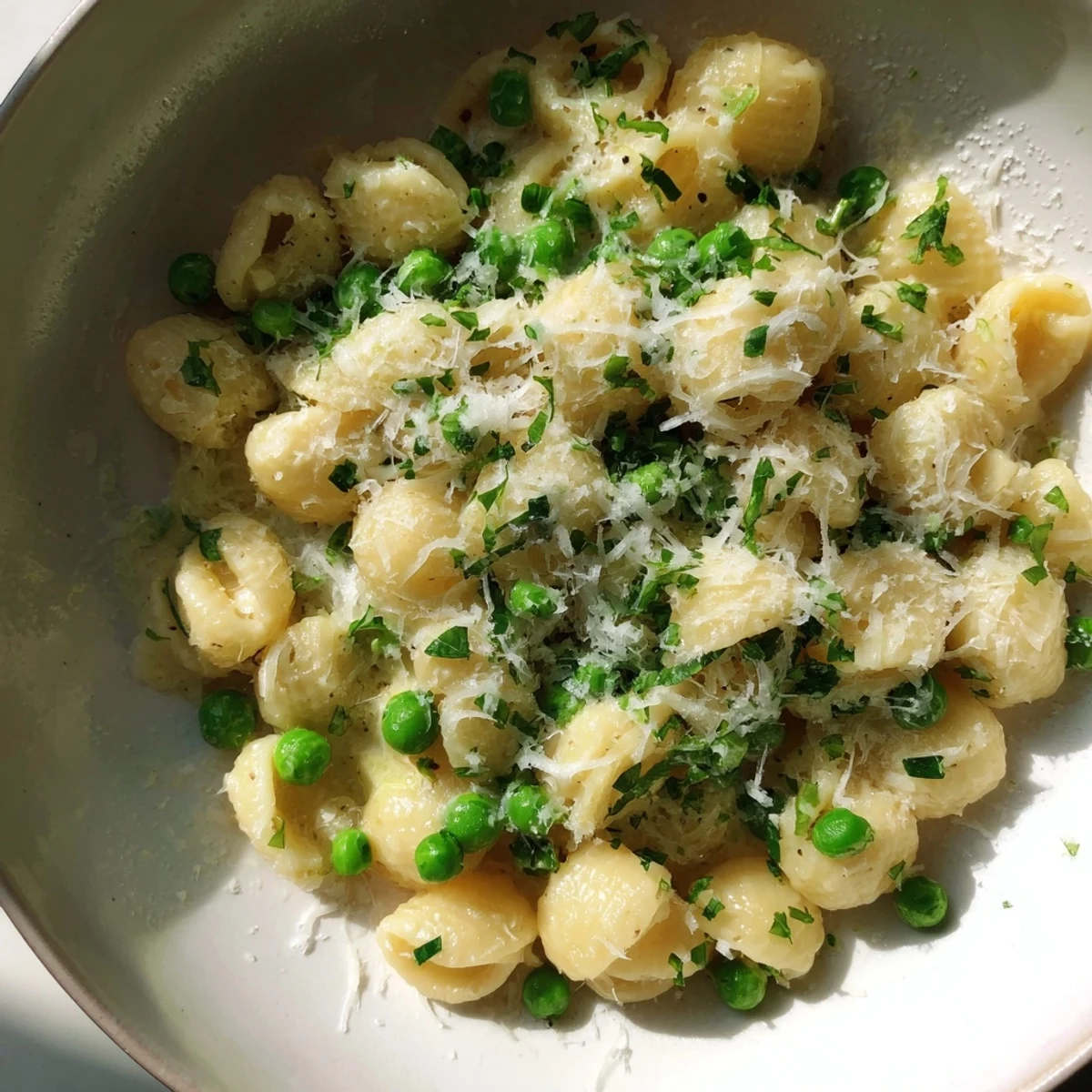 Creamy Garlic Butter Ditalini with Peas, ready to eat, with grated Parmesan sprinkled on top.