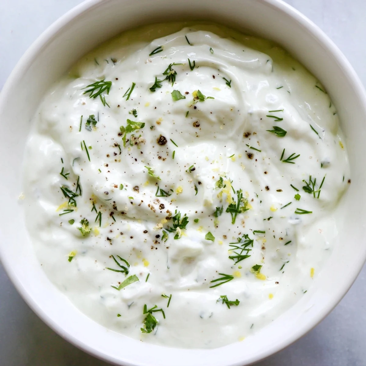 Creamy Greek Yogurt Ranch Dip, perfect for dipping crunchy veggies; see its fresh herbs.