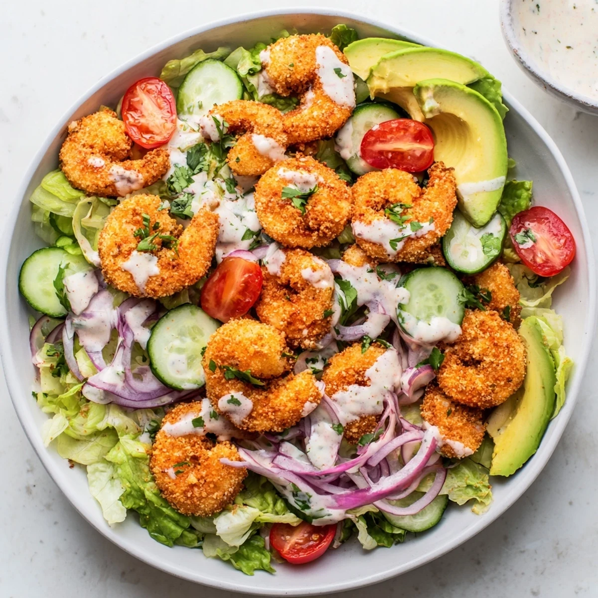 A delicious Spicy Crispy Shrimp Salad featuring perfectly cooked shrimp, avocado slices, and zesty dressing.