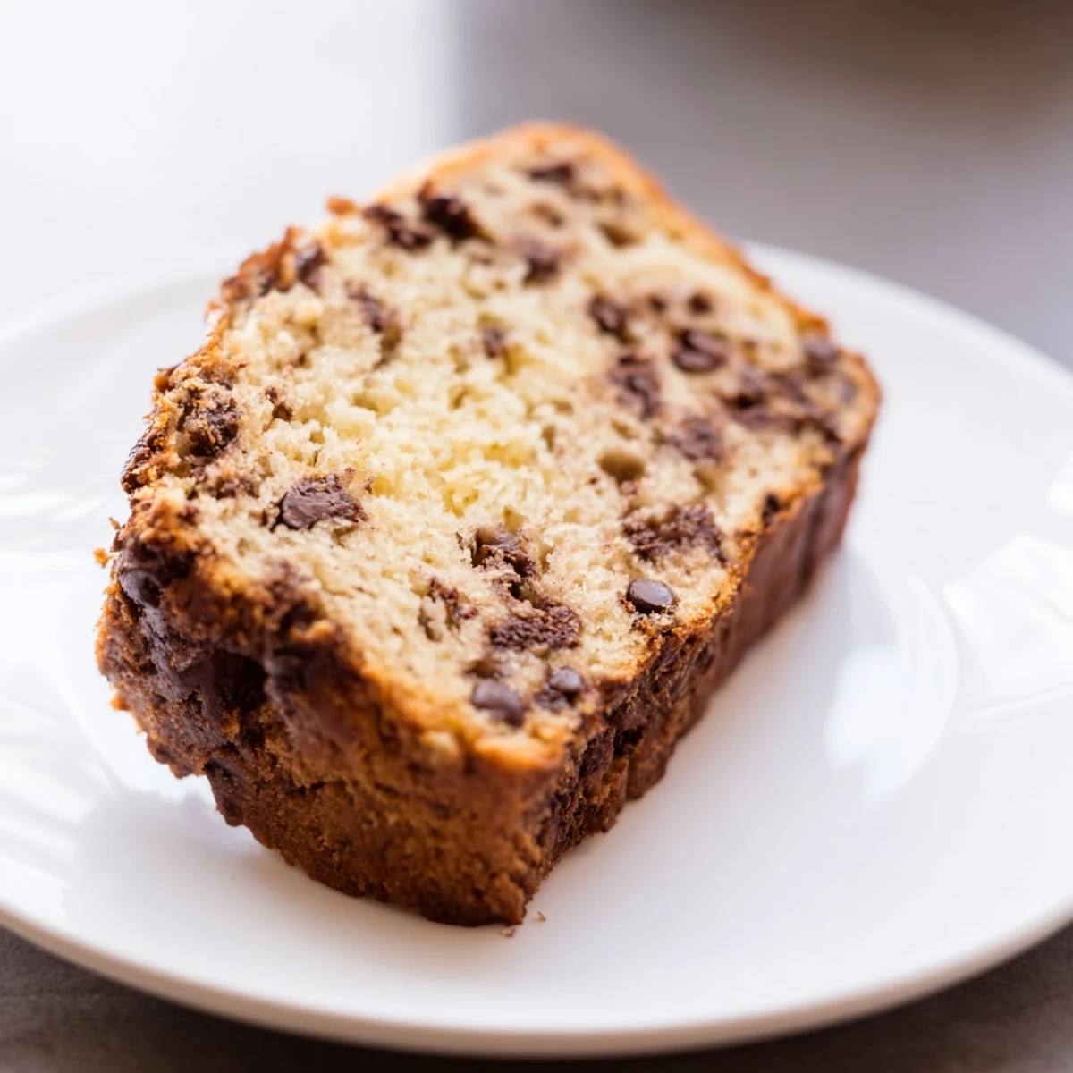 A freshly baked loaf of banana bread, moist and tender, ready to be sliced and enjoyed.