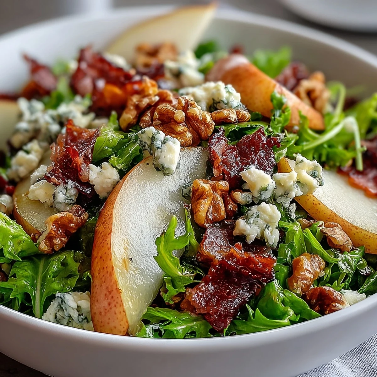 Crisp pear slices and crumbled blue cheese top a bed of frisée in this vibrant salad.