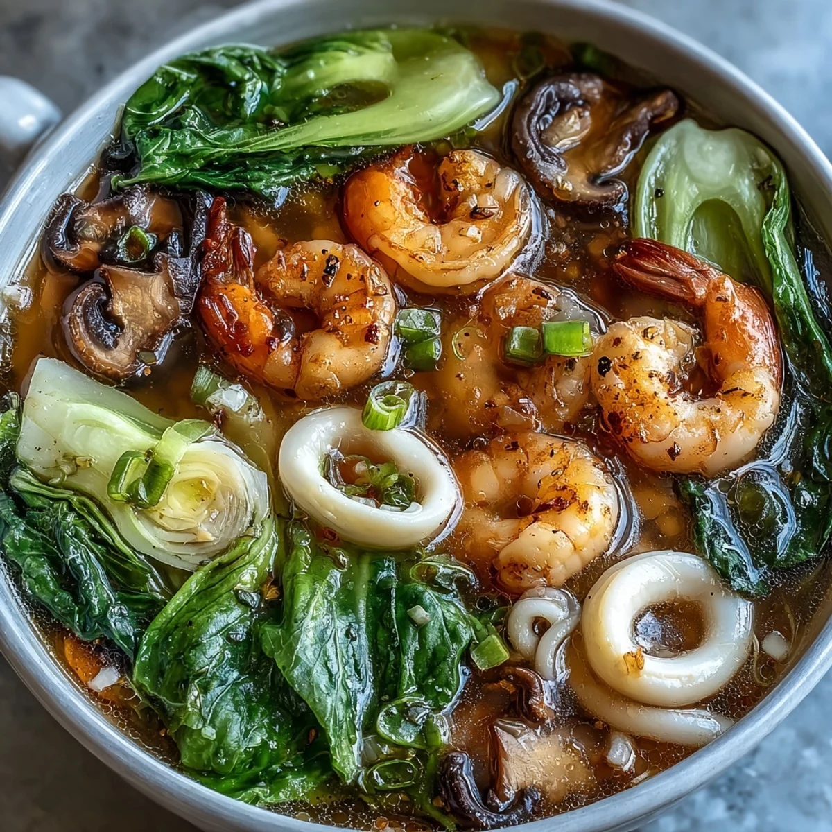 Vibrant Asian hot pot with fresh seafood and vegetables simmering in an aromatic broth, perfect for interactive dining and sharing with friends.