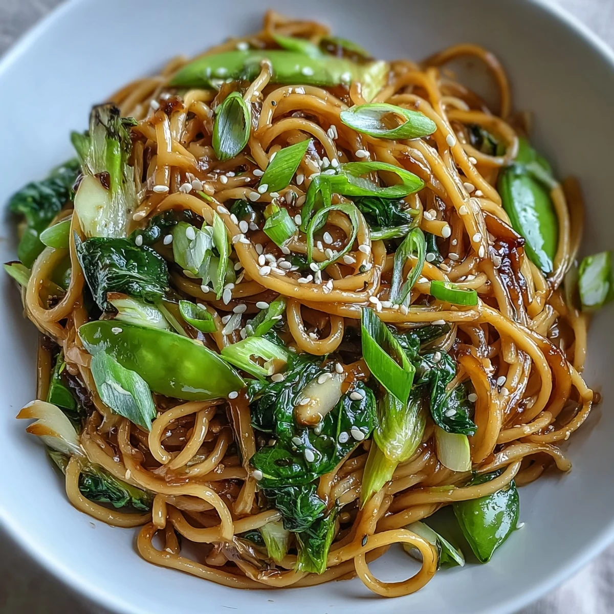 Aromatic ginger scallion noodles tossed with tender greens in a savory Asian-inspired sauce.  