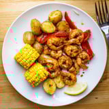 Sizzling Cajun Shrimp & Sweet Corn Platter, bursting with fresh flavors, perfect for summer.