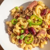 Rich and creamy Chili Cheese Dog Mac & Cheese, featuring visible bits of hot dogs in the chili.
