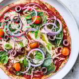 This Tortilla Pizza offers a satisfying crunch, loaded with vibrant toppings and baked cheese.