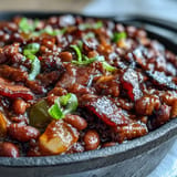 Smoky-sweet Juneteenth BBQ baked beans with tender bacon, ready to serve.