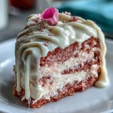 Elegant pink velvet cake with rosé wine and decadent gold drip.