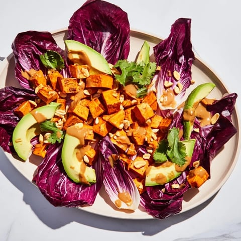 Golden roasted sweet potatoes in a Spiced Peanut Sweet Potato & Radicchio Salad Bowl, ready to be enjoyed.