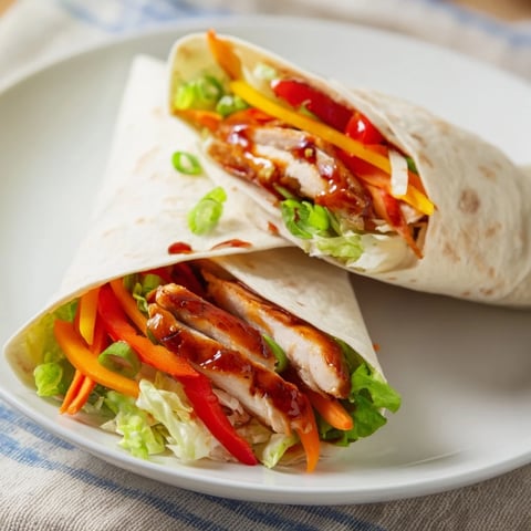 Tender, sliced Teriyaki Chicken Wrap ingredients ready for assembly on a flat surface, with vibrant colors.