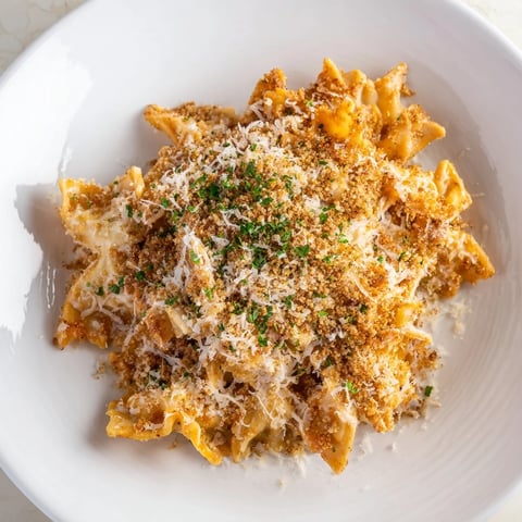 Golden-brown crust tops the bubbling Lightened Mac & Cheese Snowflake Pasta Bake with melted cheese.