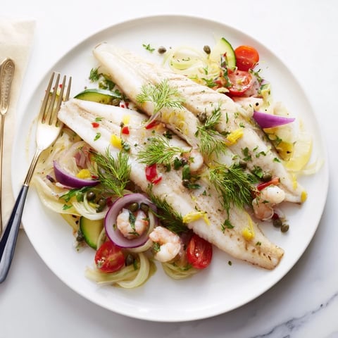 Plongeons dans l'Océan Poisson Bleu: a baked dish featuring flaky, cooked blue fish and tender vegetables.