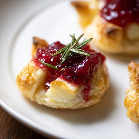 Mini Cranberry Brie Tart Wreath, golden and bubbly, perfect for holiday entertaining with flaky pastry.