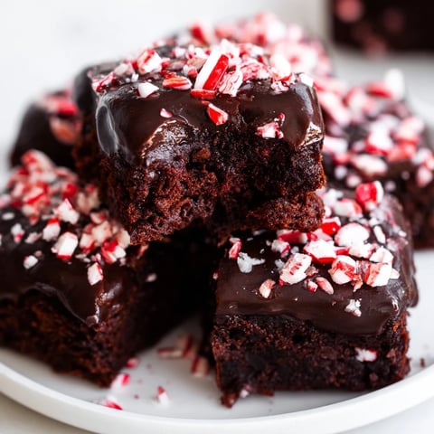 Warm, glazed Peppermint Mocha Brownie Bites, rich and fudgy, perfect for a holiday dessert table.