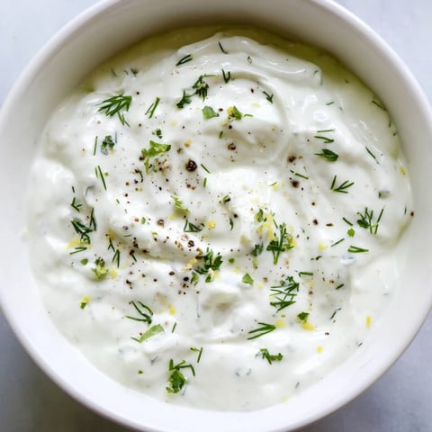 Creamy Greek Yogurt Ranch Dip, perfect for dipping crunchy veggies; see its fresh herbs.