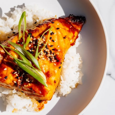 Golden, glazed Sticky Orange Salmon with Rice, a flavorful Asian-inspired meal served beautifully.