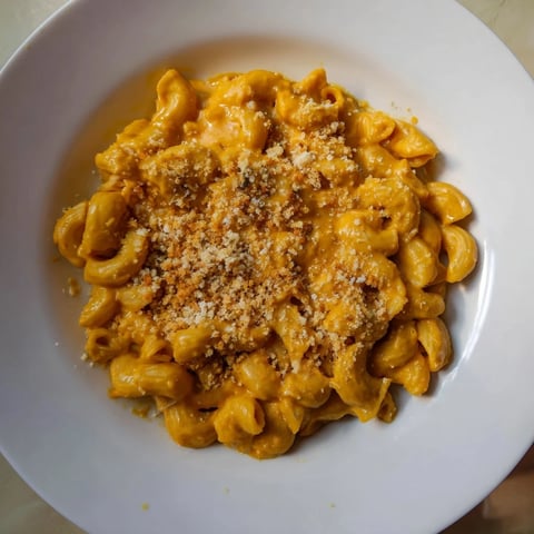 A golden-brown baked pumpkin mac & cheese, bubbling and ready to serve on a cool autumn evening.