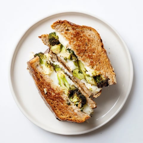The roasted broccoli florets and sharp cheddar cheese melted between golden-brown slices of sourdough bread.