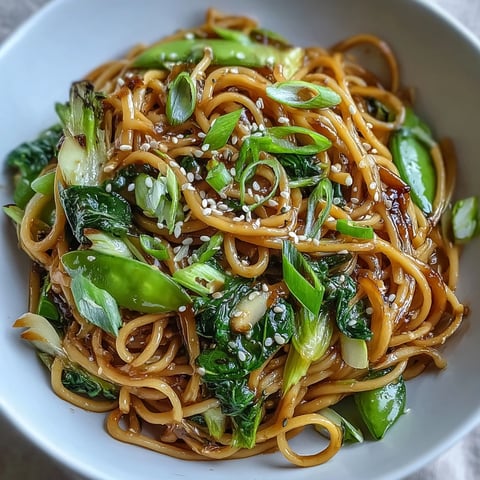 Aromatic ginger scallion noodles tossed with tender greens in a savory Asian-inspired sauce.  