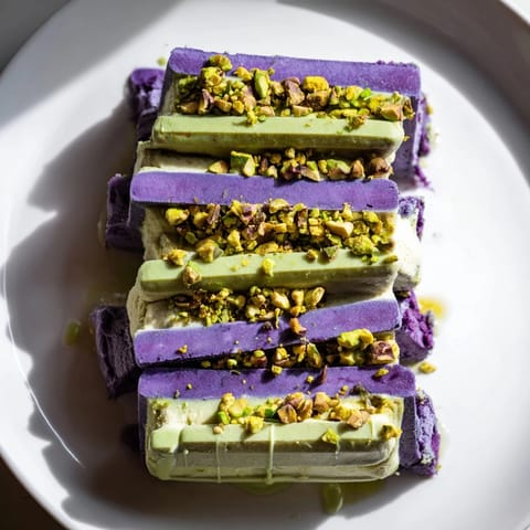 Vibrant ube and nutty pistachio ice cream bars, perfect for warm weather gatherings.  