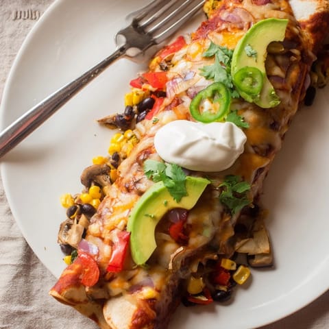 Colorful Farmers Market Vegetarian Enchiladas topped with melted cheese and fresh toppings.  