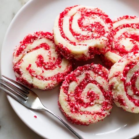 Close-up of freshly baked Candy Cane Pinwheel Cookies, showcasing the peppermint flavor and holiday beauty.