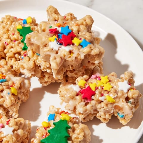 Sweet cookie cutter-shaped Rice Krispies treats topped with colorful sprinkles for a fun snack.