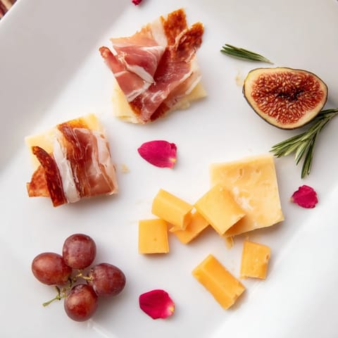 Artfully arranged Crimson Crest charcuterie ingredients, including cured meats, red wine-soaked cheeses, and grapes.