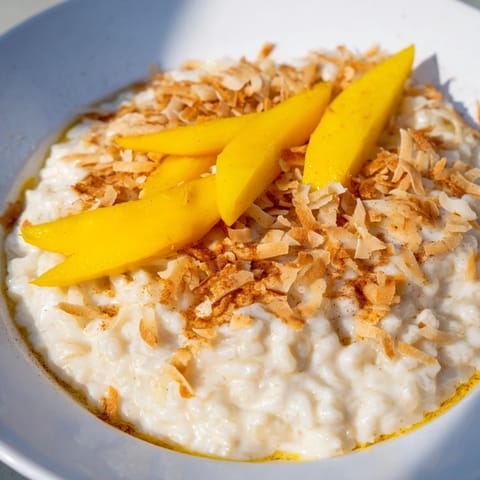Warm bowl of Toasted Coconut Rice Pudding, infused with coconut and cinnamon, ready to eat.
