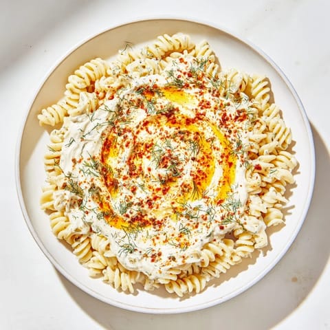 A generous bowl of Turkish Yogurt Pasta, with fusilli pasta coated in creamy yogurt sauce.