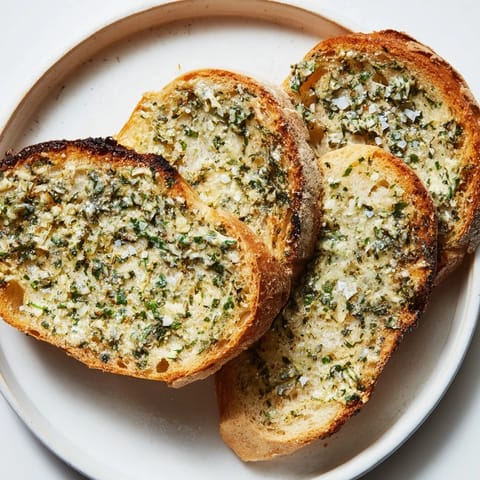 Warm, buttery Herb Butter Toast with crispy edges, ready to serve as a delicious snack.