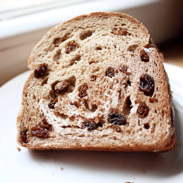 Homemade Protein Cinnamon Raisin Bread, soft and fluffy, a delicious high-protein treat.