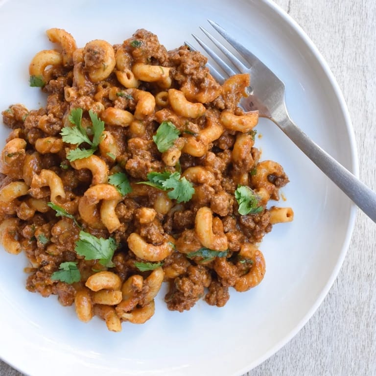 Deliciously spicy Chipotle Creamy Beef Pasta garnished with vibrant coriander leaves.  