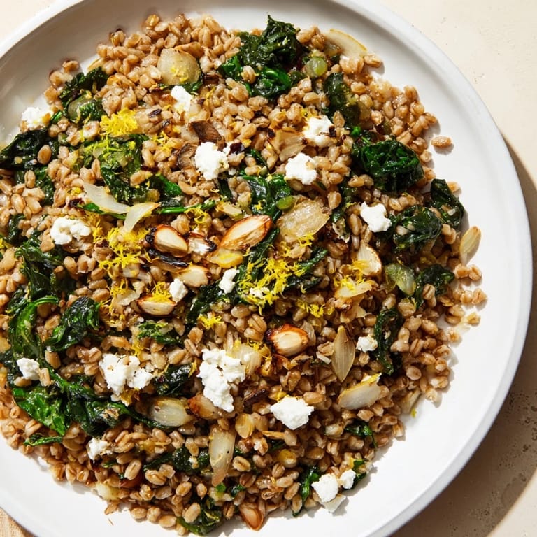 This comforting Farro & Greens Pilaf shows perfectly cooked grains with fresh greens and a lemon zest aroma.