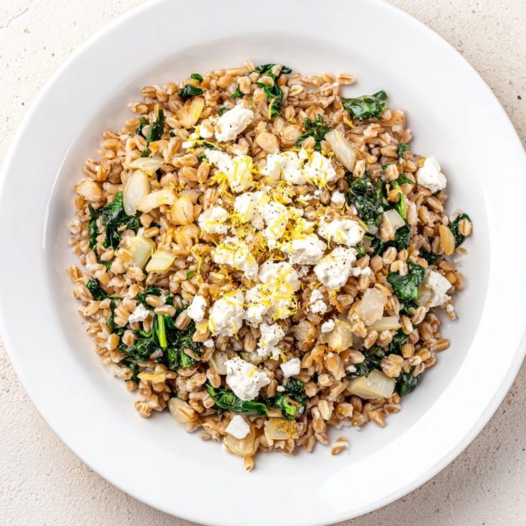 Close-up of a delicious serving of Farro & Greens Pilaf, ready to enjoy as a vegetarian meal.