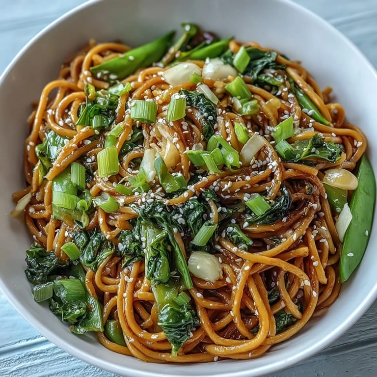 Silky noodles coated in fragrant ginger-scallion oil, served with vibrant sautéed bok choy and snap peas.  