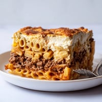 Indulge in Greek Pastitsio, a savory layered pasta and beef dish.