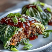 Korean cabbage rolls with spicy beef filling, steamed until tender and served with savory dipping sauce.